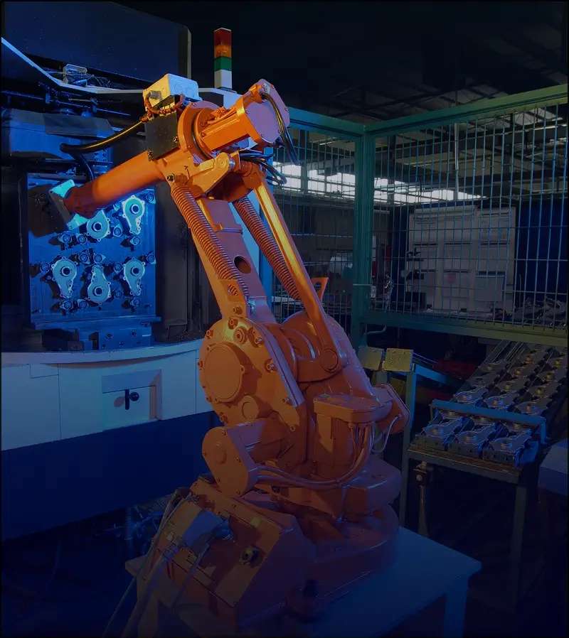 Orange industrial robot in a factory setting.